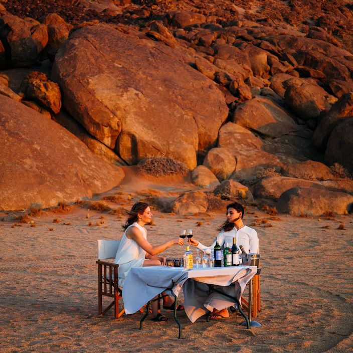 Enjoy a sundowner setup at Wilderness Kulala Desert Lodge