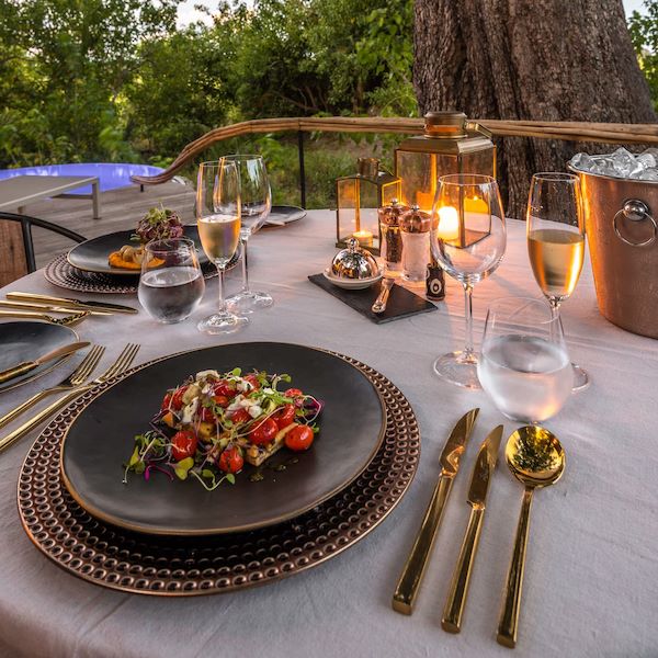 A private dining setup on the deck at Wilderness Mombo