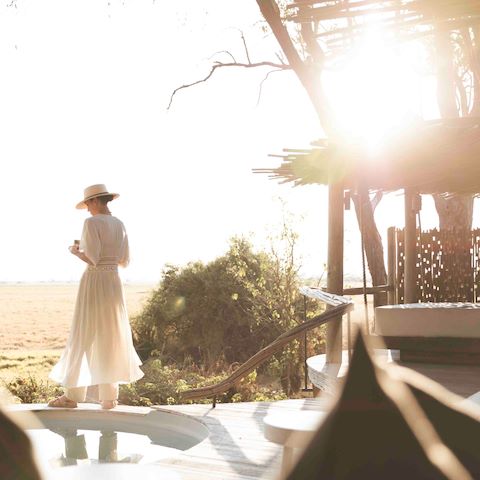 Guest standing on private deck at suite at Wilderness Mombo