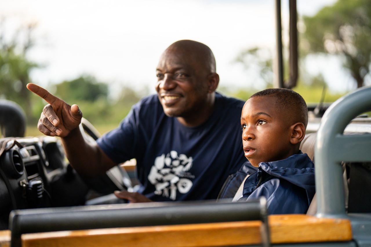 Guide showing a local child the wonder of the Wilderness CITW