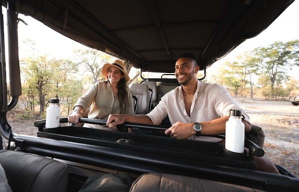 Couple enjoying a safari game drive Wilderness Botswana