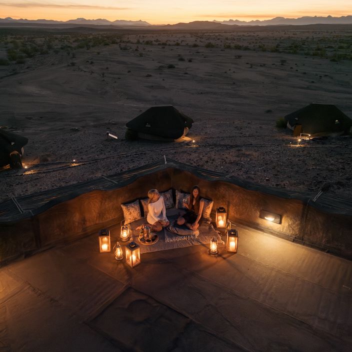 Guests at Doro Nawas enjoying dusk in camp